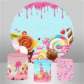 Candy-themed party supplies featuring plates and boxes decorated with lollipops, swirls, and dripping pink frosting.