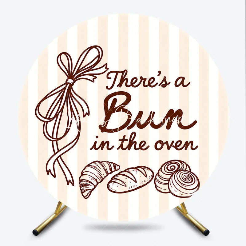 Lofaris Neutral Striped There’s a Bun in the Oven Round Backdrop Baked Goods and Ribbon for Baby Shower Decor.