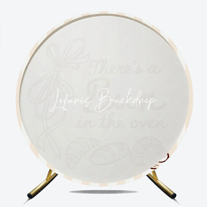 Lofaris Neutral Striped There’s a Bun in the Oven Round Backdrop Baked Goods and Ribbon for Baby Shower Decor.