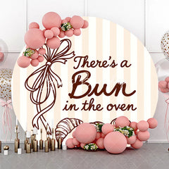 Lofaris Neutral Striped There’s a Bun in the Oven Round Backdrop Baked Goods and Ribbon for Baby Shower Decor.