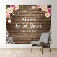 Rustic wooden backdrop banner with floral accents and ’Alice’s Bridal Shower’ text.