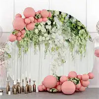 Decorative arch adorned with cascading greenery and coral-colored balloons.