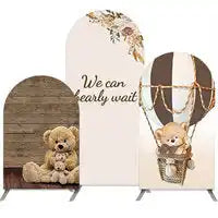 Decorative backdrop featuring teddy bears, a hot air balloon, and text reading ’We can bearly wait!’
