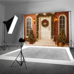 Lofaris Christmas Front Porch Photography Backdrop White Door with Brick Wall and Garland Holiday Photo Background