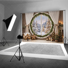 Lofaris Cozy Winter Holiday Backdrop with Round Window Snowy Forest and Festive Christmas Tree Decorations