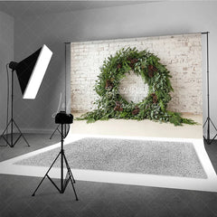 Lofaris Green Evergreen Wreath and Pinecone Holiday Backdrop Rustic Winter Christmas Party Decor on White Brick Wall