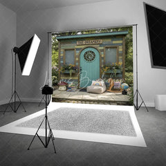 Lofaris Whimsical Rustic Wooden Playhouse Photography Backdrop with Arched Teal Door and Sun Carving Fairy Tale Garden Scene