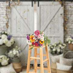 Lofaris White Brick Wall and Rustic Barn Doors Photography Backdrop with Elegant Floral Arrangements Wedding Event Decor