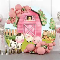 Pink barn-themed party backdrop with balloon decorations and farm animal cutouts.