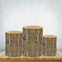 Three rustic tree trunk pedestals with smooth top surfaces and natural bark textures on the sides.
